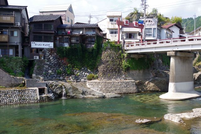 険しい崖に石を敷き詰めた上に建つ建物。