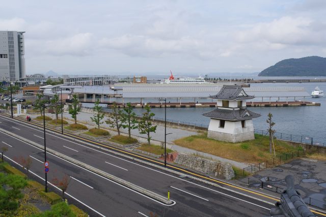 道路の向こうに報時鐘と高松港。