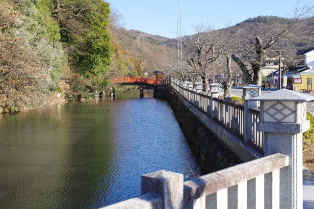 道路から最初の朱色の橋を望む。家紋の灯籠も印象的。