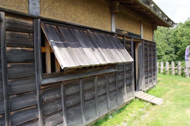 黒い木壁に木の跳ね上げ窓。