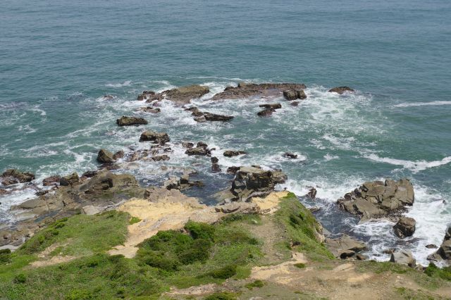 海上の岩場とそれに続く陸地の部分。